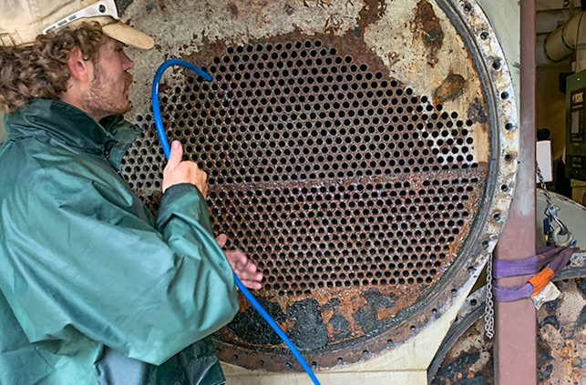 Sensible Solutions employee brushing tubes